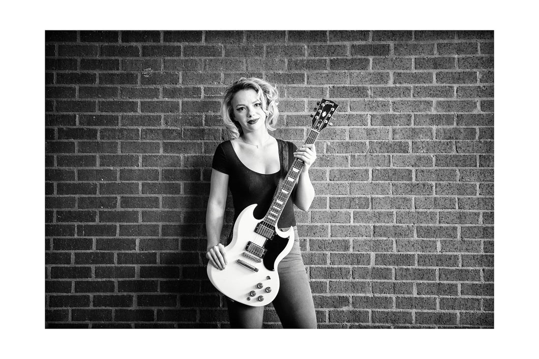 Samantha Fish posing for me while I made portraits for my Six String Slingers project to benefit The Roots of Music program in New Orleans. *50% OF THE PROFITS FROM THIS IMAGE GO TO THE ROOTS OF MUSIC PROGRAM WHICH HELPS TEACH CHILDREN IN NEW ORLEANS HOW TO BE PART OF A MARCHING BAND. IN ADDITION IT OFFERS TUTORING AND A MEAL.